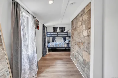 a hallway with a bed and a couch