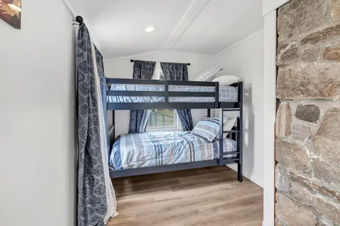 a bedroom with a bed and a night stand