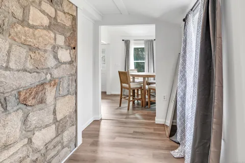 a view of entryway with furniture and wooden floor