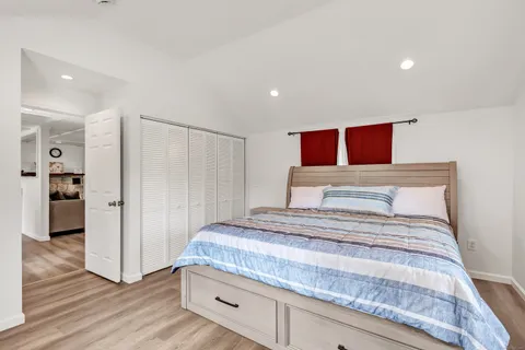 a bedroom with a large bed and a window