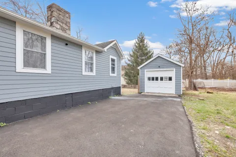 a view of a house with a yard and wooden fence
