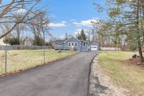 a view of a house with swimming pool and a yard