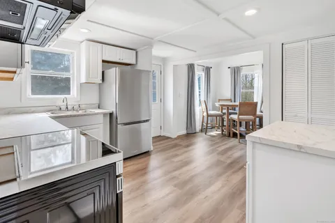 a kitchen with stainless steel appliances a stove a sink and a refrigerator