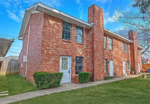 a brick building with a yard