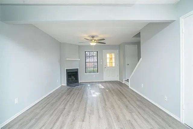 wooden floor in an empty room with a fireplace