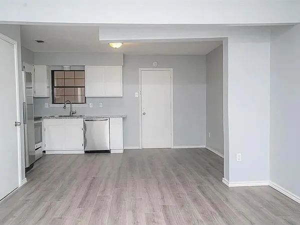 a view of kitchen with wooden floor and electronic appliances