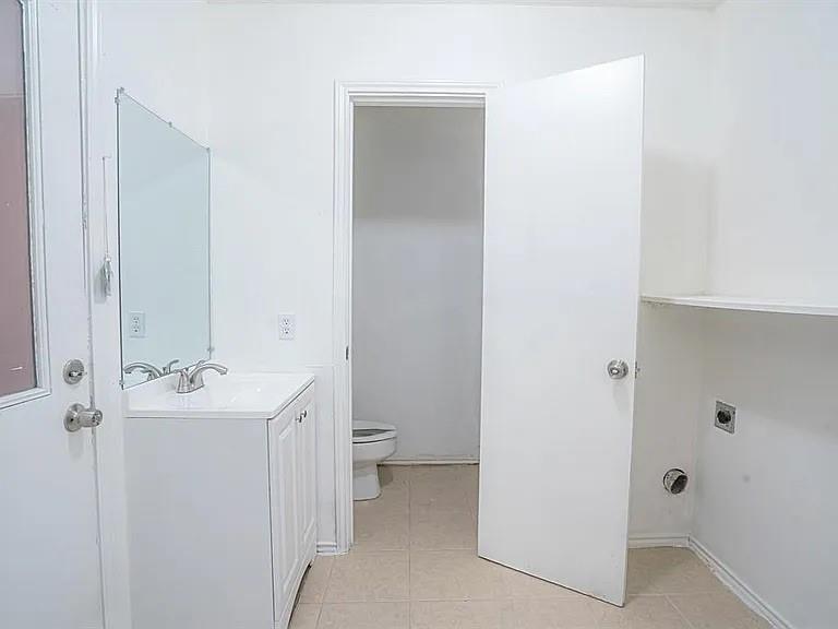 210 Rolston Road, Unit 5 Irving, TX 75060 - Photo 4 of 9 a bathroom with a sink toilet and shower