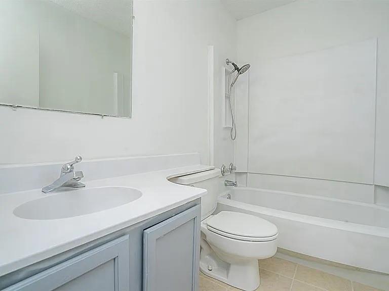 210 Rolston Road, Unit 5 Irving, TX 75060 - Photo 6 of 9 a bathroom with a sink a toilet and shower
