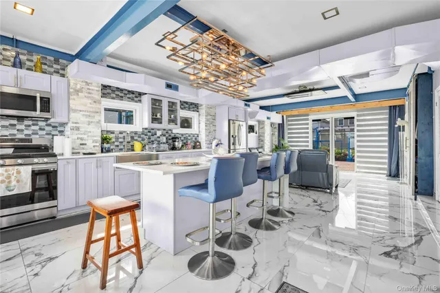 a kitchen with stainless steel appliances granite countertop a stove a sink and a cabinets