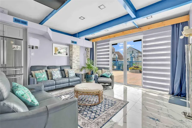 a view of a dining room with furniture large windows and wooden floor