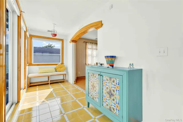 a bedroom with a bed and a dresser with mirror