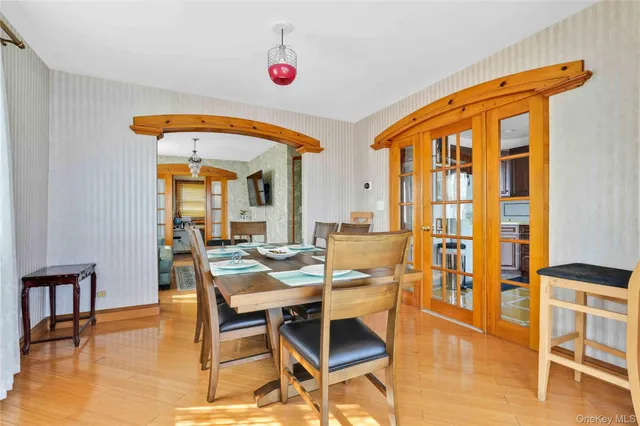a view of a dining room with furniture a chandelier and wooden floor