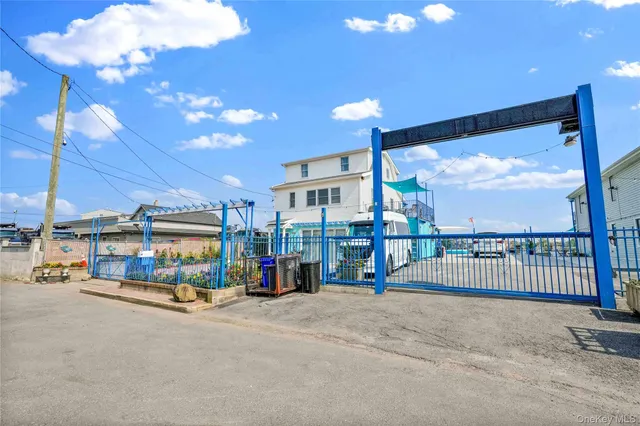 a front view of a building with a garden and plants