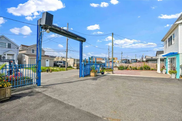 a front view of a house with a yard and potted plants