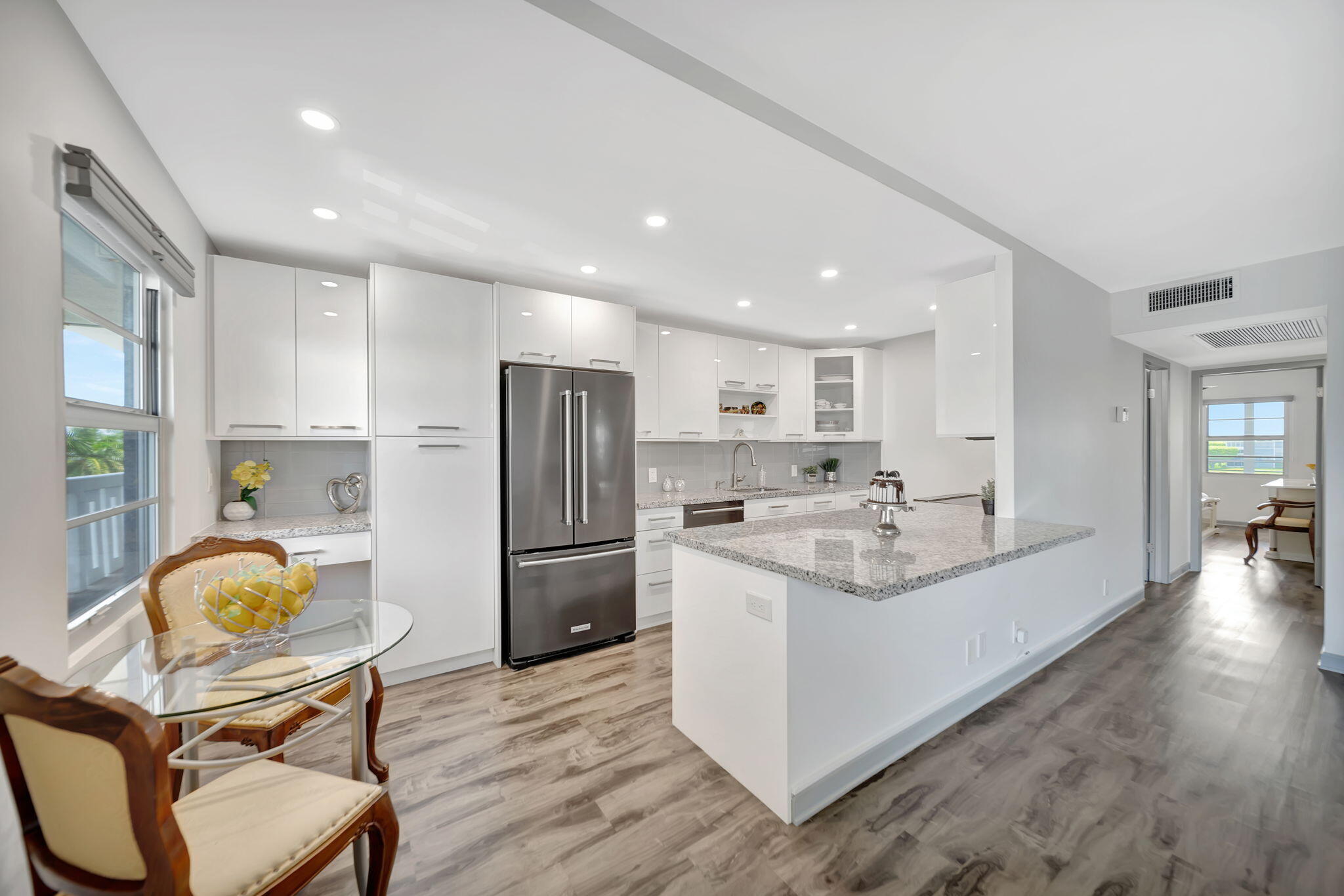 4063 Exeter Boca Raton, FL 33434 - Photo 1 of 55 a kitchen with refrigerator a chair and wooden floor