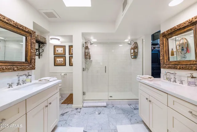 a spacious bathroom with a double vanity sink mirror and double