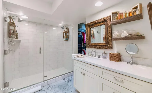 a bathroom with a granite countertop sink mirror and shower