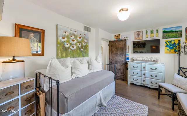 a bedroom with furniture and a dresser