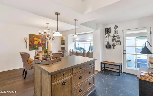 a view of a dining room and livingroom with furniture wooden floor a chandelier
