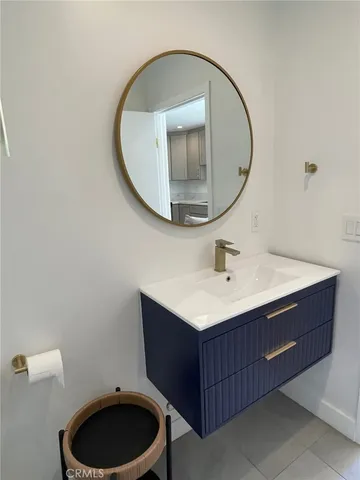 a bathroom with a sink mirror vanity and toilet
