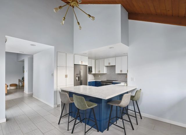 a kitchen with a dining table cabinets and appliances