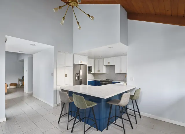 a kitchen with a dining table cabinets and appliances