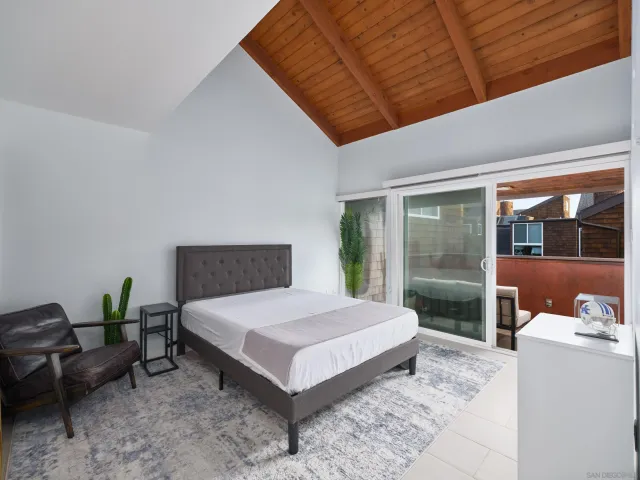 a bedroom with a bed and large window with outer view