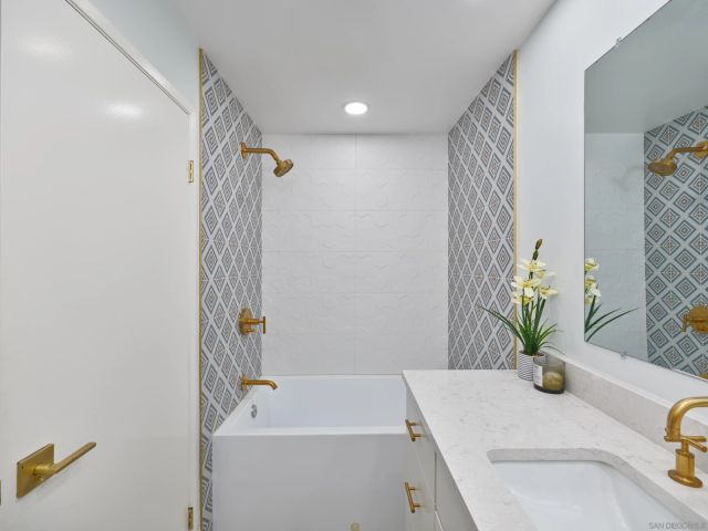 a bathroom with a sink a bathtub and a shower