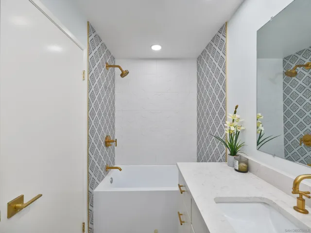 a bathroom with a sink a bathtub and a shower