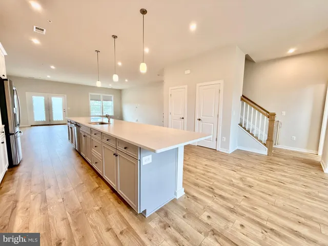 a view of kitchen with cabinets and wooden floor