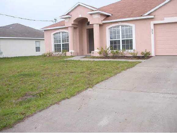 573 Southwest Lagrange Palm Bay, FL 32908 - Photo 1 of 6 front view of a house with a yard