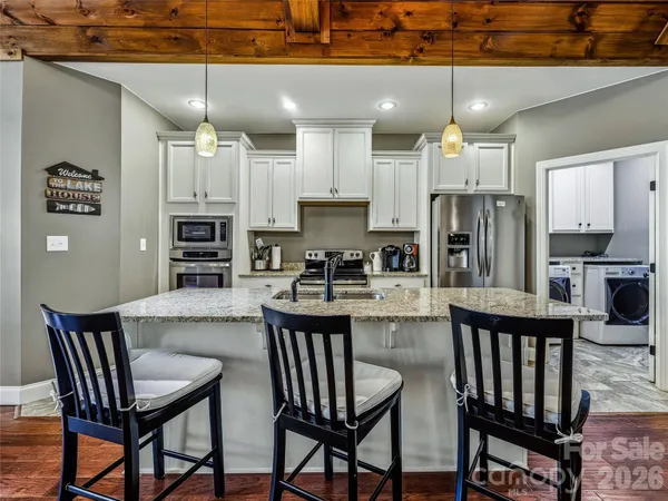 a kitchen with kitchen island a sink and stove