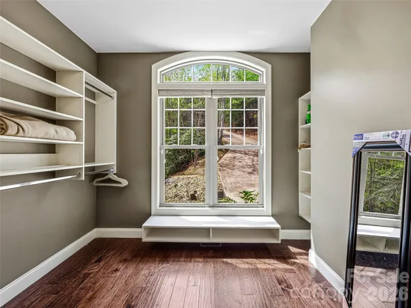 a spacious bathroom with a granite countertop sink and a mirror