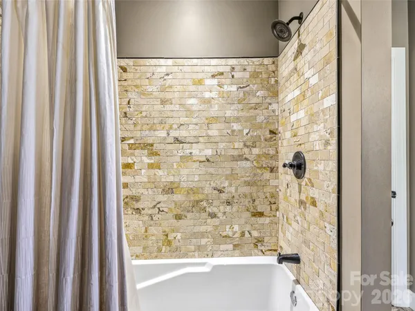 a bedroom with a bed a mirror and a window