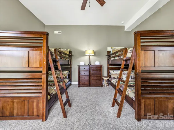 a room with pool table and windows