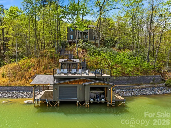 a view of a roof deck with couches and wooden floor