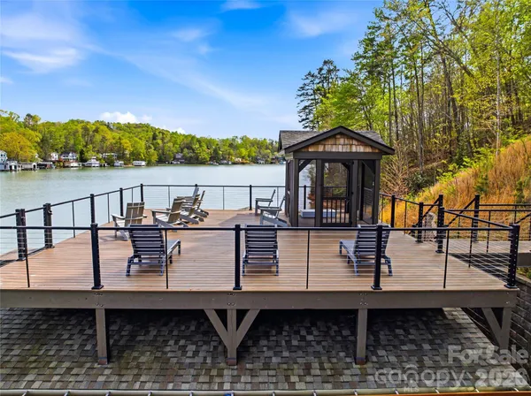 swimming pool view from a balcony with outdoor seating