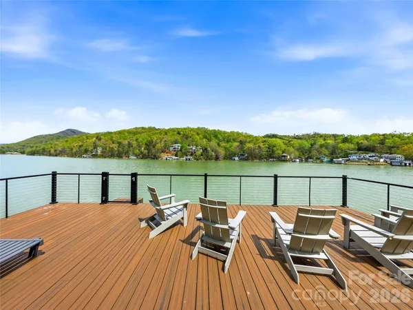 a view of backyard with a large window and wooden floor