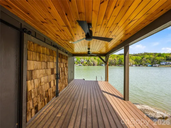 a backyard of a house with wooden floor and city view