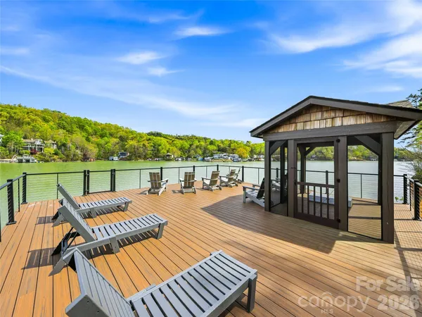 a view of a roof deck with couches and wooden floor