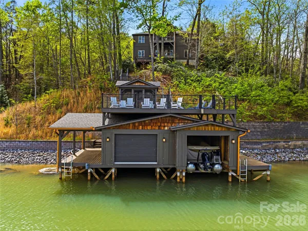 a view of a chairs and table in the pool and chair in the patio
