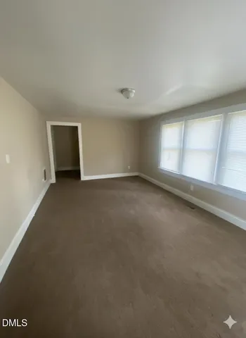 en empty room with closet and wooden floor