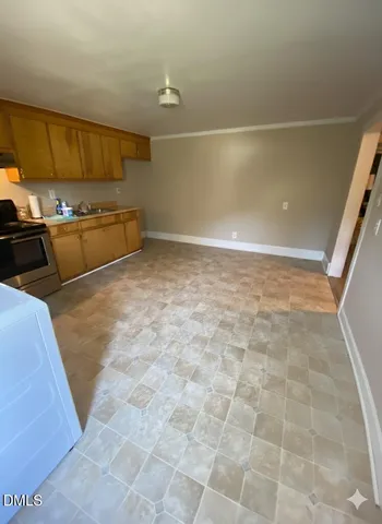 front view of a house with a tree in the background