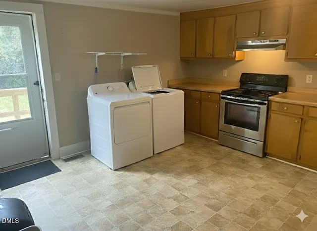 a view of a refrigerator in kitchen and utility room