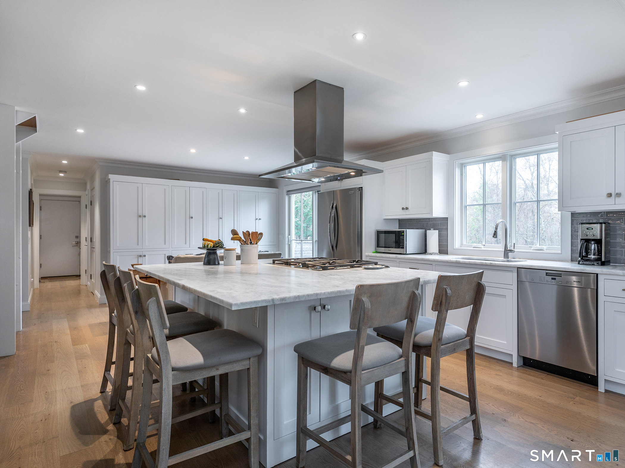 67 Sunset Lane Washington, CT 06794 - Photo 9 of 31 a kitchen with stainless steel appliances kitchen island granite countertop a table and chairs in it