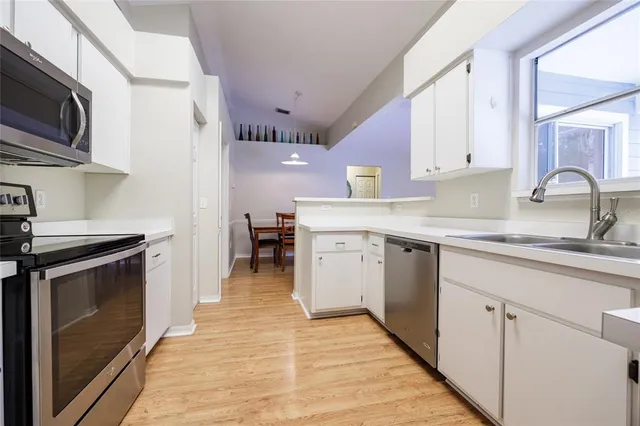 a kitchen with a sink stove and microwave