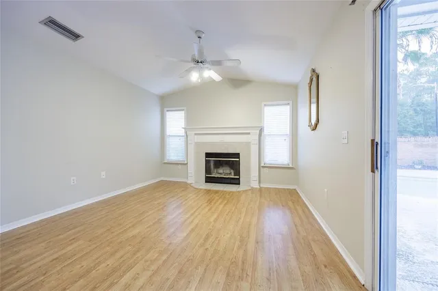 wooden floor in an empty room with a fireplace