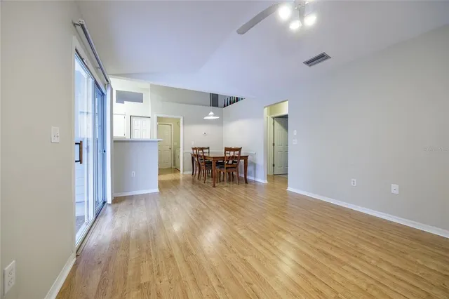 a dining room with furniture and wooden floor