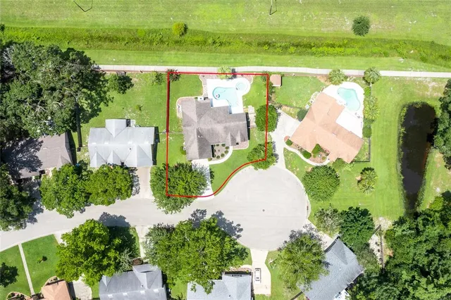 an aerial view of a house with a yard and lake view