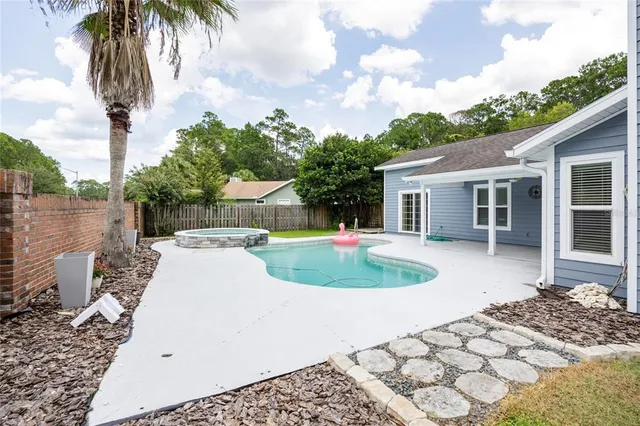 a view of a swimming pool and a yard